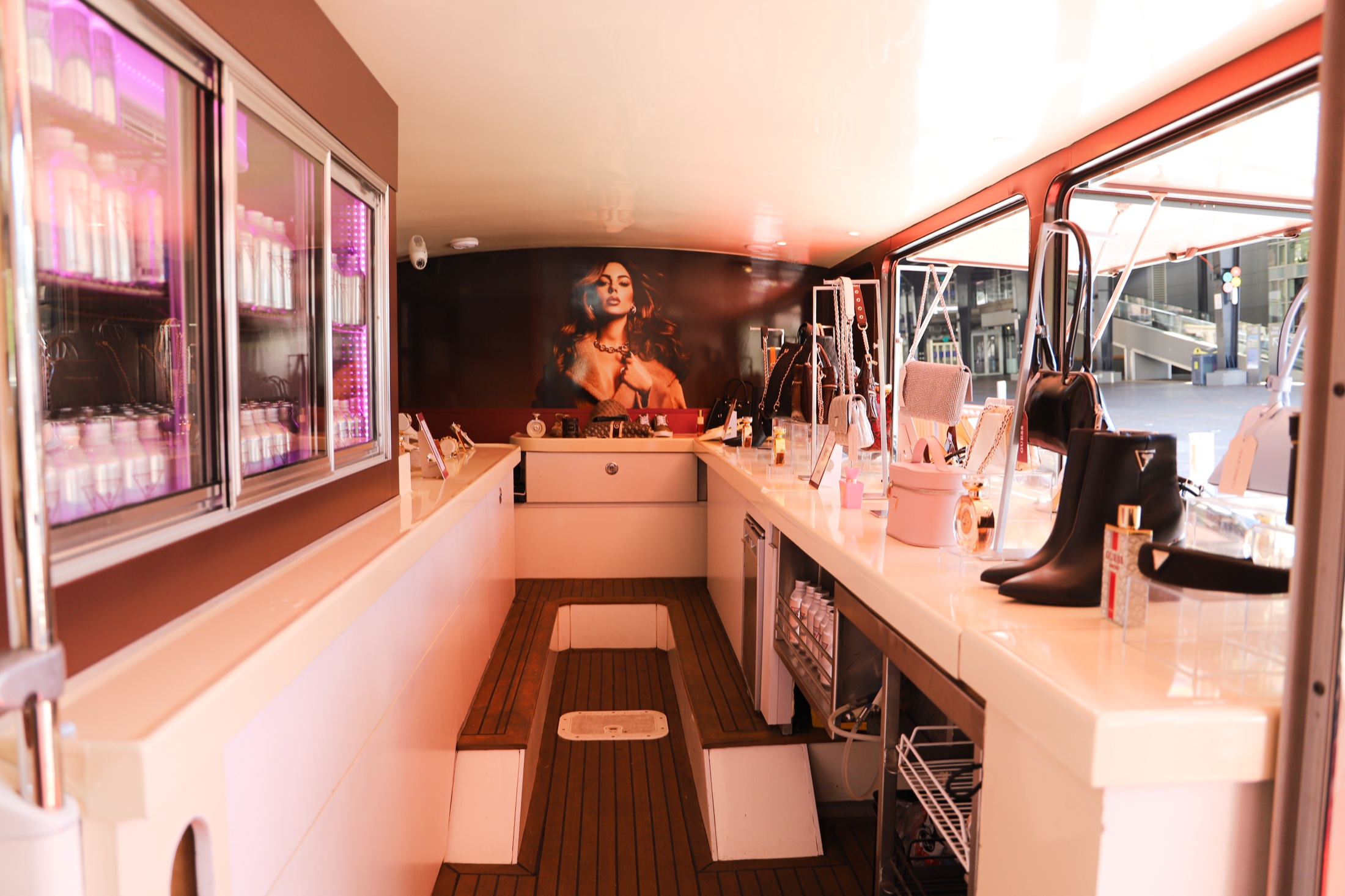 Illuminated GUESS product and service counter inside the bus