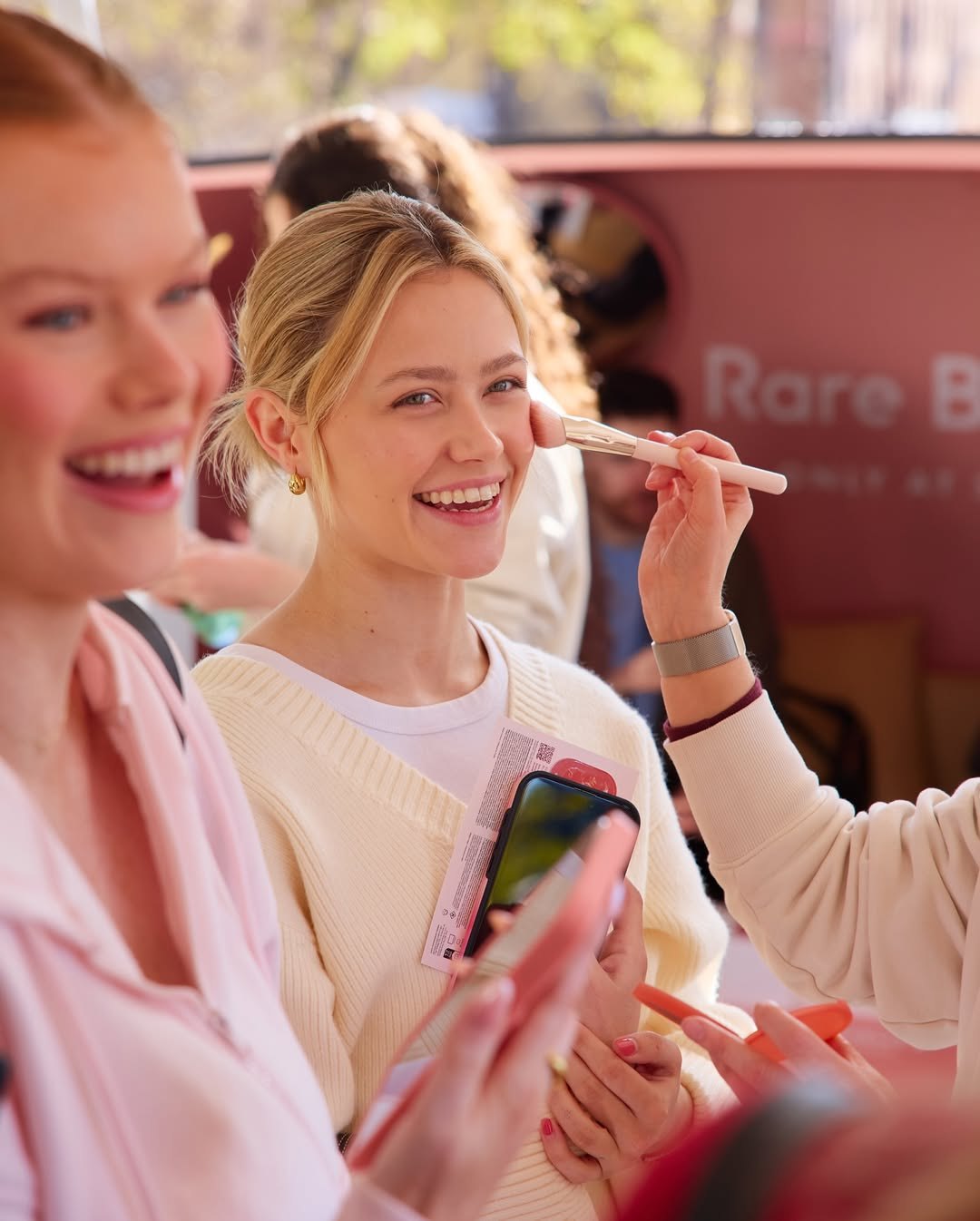 Visitors inside the pink Rare Beauty bus interior